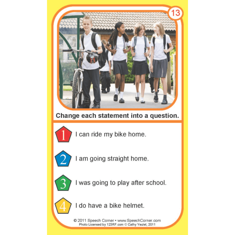 A printed educational card with a yellow border, featuring a photo of four school children walking outdoors and a numbered list of statements to convert into questions. The card includes the text 'Change each statement into a question.