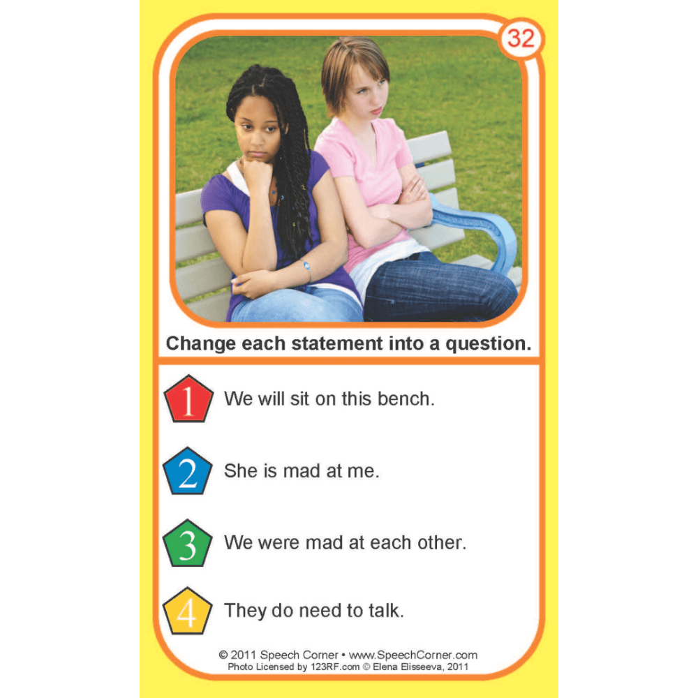 A printed educational card with a yellow border, featuring a photo of two girls sitting on a bench in a grassy area, plus four numbered English sentences with instruction text at the top and bottom.