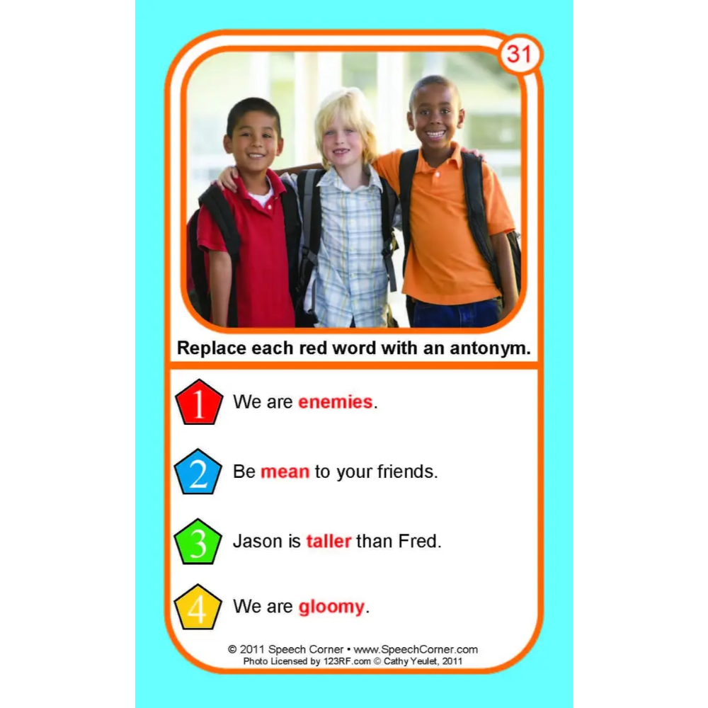 A printed educational card with a turquoise border and a central photo of three children. Below the photo, the card reads, 'Replace each red word with an antonym.