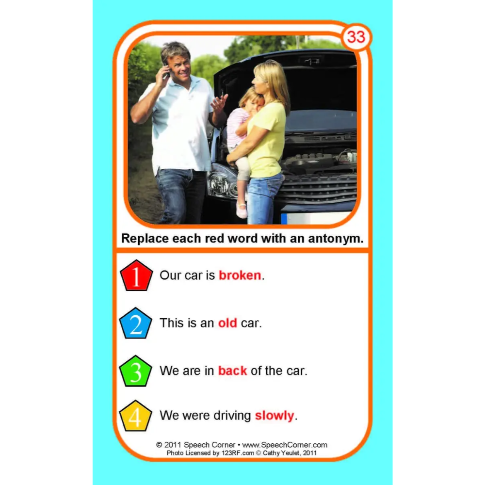 A printed educational card with a photo of a family standing by a broken-down car, plus text exercises to replace red words with antonyms. The card is shown against a light blue background.