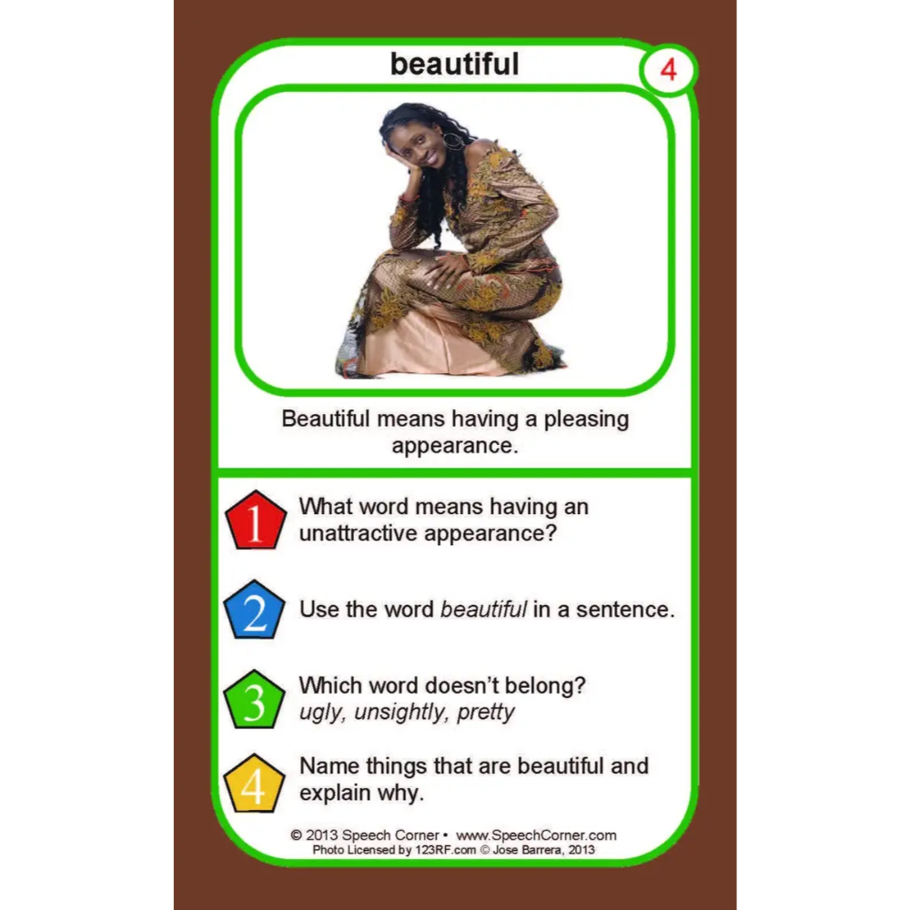 A printed educational card titled 'beautiful' with a green border, a small photo of a seated woman, and text defining the word and asking four learning questions. The card is centered on a brown background.