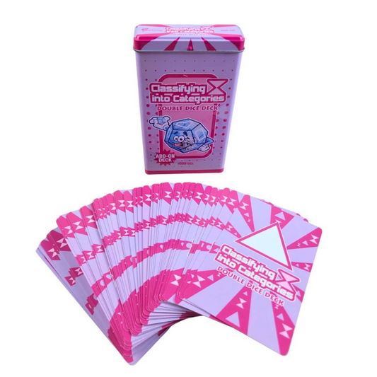 A pink and white deck of double dice cards displayed as a fanned-out stack in front of its matching metal tin box on a plain white background.