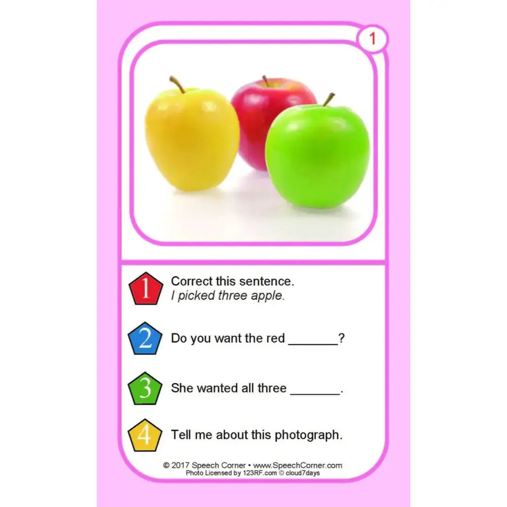 A pink educational card featuring three apples (yellow, red, and green) in a photo box at the top, with numbered exercise text below including 'Correct this sentence. I picked three apple.
