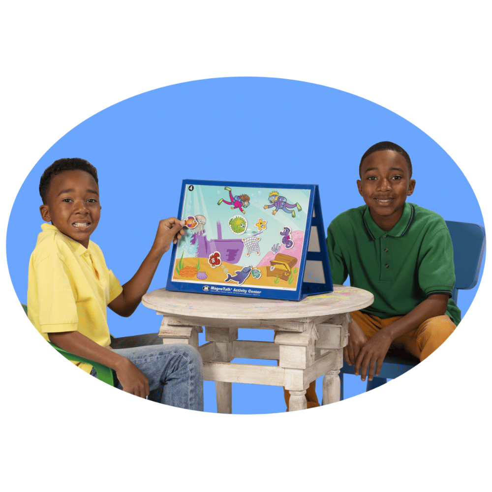 Two students using the MagneTalk® Barrier Game Board Stand in their classroom