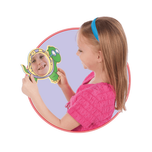 A young girl using the turtle Animal Foam Mirror in speech-language therapy
