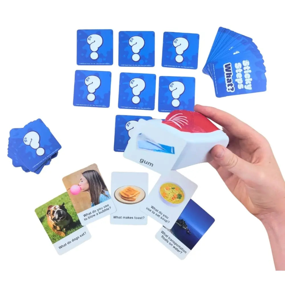 A hand holding a white and red card shaper over a set of blue cards with question marks, surrounded by example flashcards on a white background.
