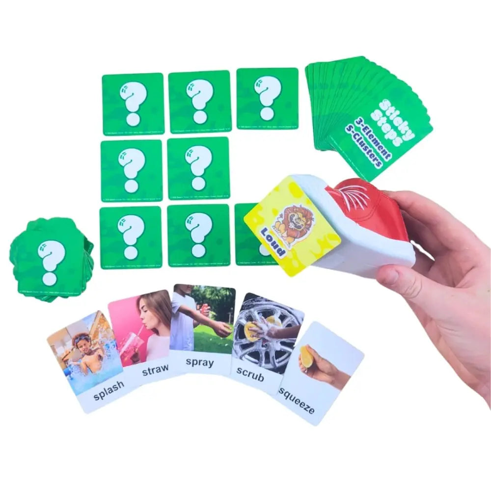 A hand holds a red and white card sticky shoe over a fan of green cards with white question marks. Below, several illustrated cards are laid out showing action words like splash, straw, spray, scrub, and squeeze on a white background.