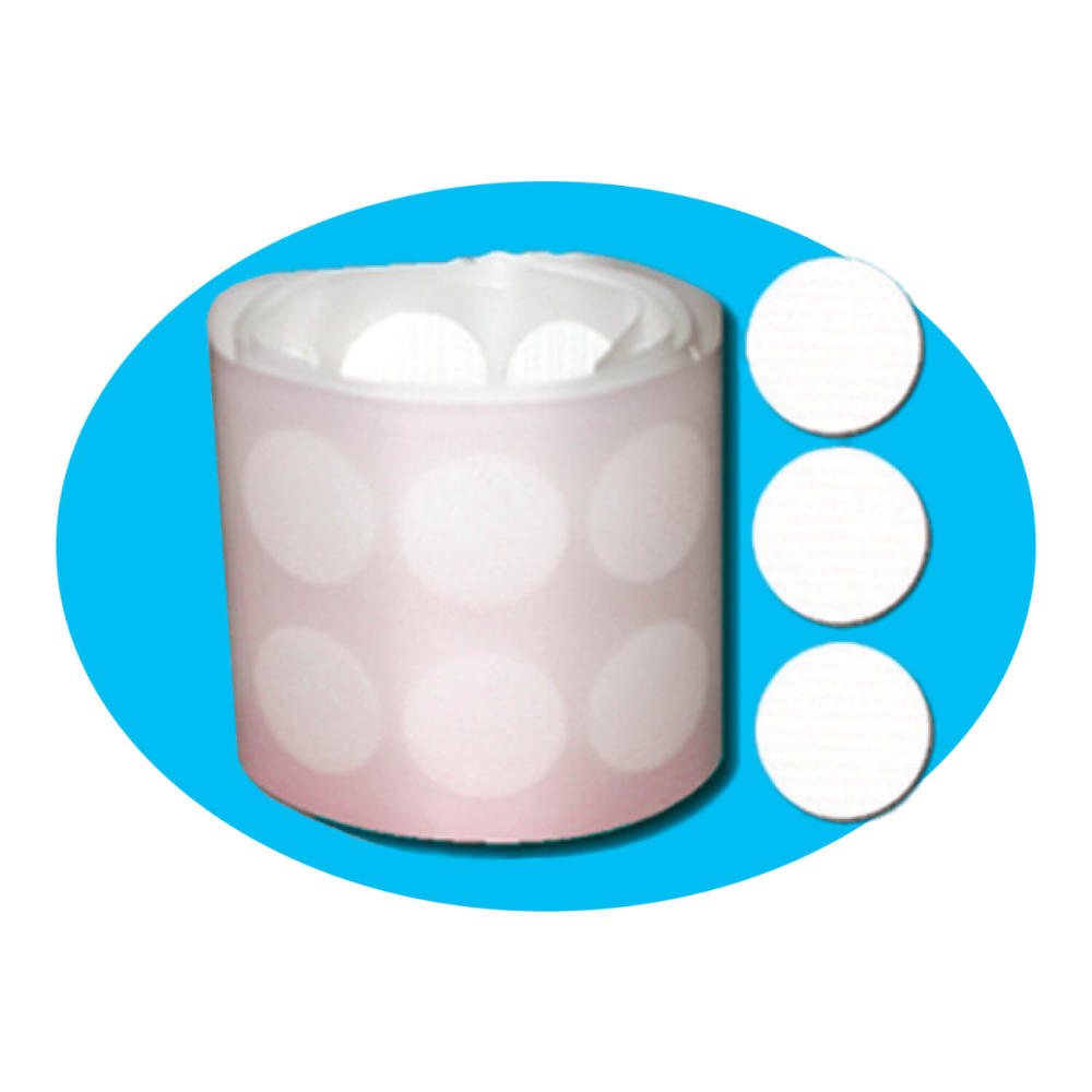 A roll of round adhesive labels in pale pink with white polka dots, shown next to three individual white circular labels on a white background with a bright blue oval backdrop.