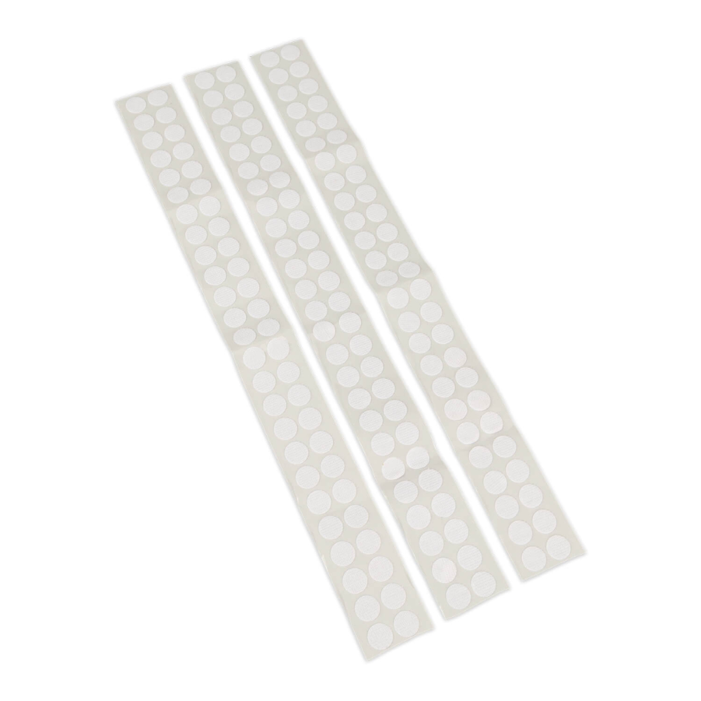 Three strips of round adhesive velcro dots on a plain white background.